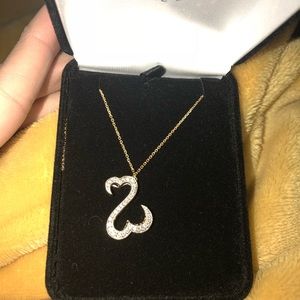 Selling this beautiful open heart gold necklace.